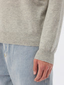 Man wearing a gray cashmere sweater on a white background. #color_steel_silver