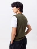 Back view of a man wearing the olive green Timeless V-Neck Cashmere Vest over a white T-shirt