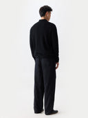 Person wearing a black outfit on a white background