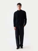 Person wearing a black outfit on a white background