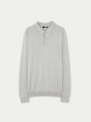 A light gray heathered knit polo cashmere sweater with a three-button placket, displayed flat against a clean, off-white background. #color_urban-gray