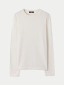 A long-sleeve crewneck knit cashmere sweater in a warm off-white or cream color, displayed flat against a light gray background. #color_pure-white