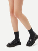 Unisex Cashmere Rib Knit Bed Socks Charcoal worn by model, detail view on white background
