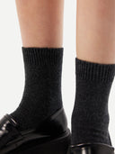Unisex Cashmere Rib Knit Bed Socks Charcoal worn by model, detail view on white background