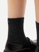 Unisex Cashmere Rib Knit Bed Socks Charcoal worn by model, detail view on white background