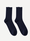 A pair of dark navy blue ribbed crew socks displayed flat against a light off-white background.