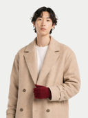 Man wearing a beige coat and red gloves on a white background. #color_bordeaux