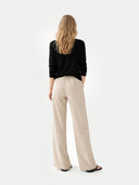 Women's Black Cashmere V-Neck Sweater worn by model, back view on white background