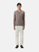 A gray knit zip-up cashmere bomber with a V-neck, ribbed cuffs and hem, and a sleeve pocket, shown against a light gray background. #color_cool-gray