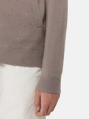 A gray knit zip-up cashmere bomber with a V-neck, ribbed cuffs and hem, and a sleeve pocket, shown against a light gray background. #color_cool-gray