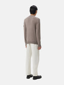 A gray knit zip-up cashmere bomber with a V-neck, ribbed cuffs and hem, and a sleeve pocket, shown against a light gray background. #color_cool-gray