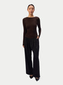 Model wearing the CashmereTech Ultralight Jersey in Shitake, a fitted boat-neck long-sleeve top, front view