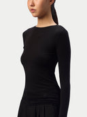 Detail of the boat neckline and smooth jersey of the Black CashmereTech top