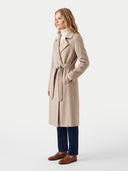 Model wearing the Natural Color Cashmere Wrap Coat with Belt in Taupe, three-quarter side view