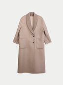 A light taupe knit coat with a ribbed shawl collar, three-quarter sleeves, and front patch pockets, shown against a light gray background.