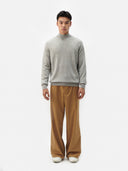 A light gray heather knit crewneck cashmere sweater with long sleeves and ribbed cuffs, displayed against a light gray background. #color_steel-silver