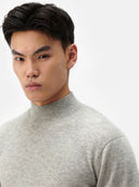 A light gray heather knit crewneck cashmere sweater with long sleeves and ribbed cuffs, displayed against a light gray background. #color_steel-silver