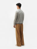A light gray heather knit crewneck cashmere sweater with long sleeves and ribbed cuffs, displayed against a light gray background. #color_steel-silver