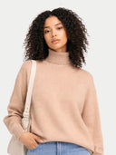 Women's T-Neck Organic Colour Cashmere Sweater Beige worn by model, detail view on white background