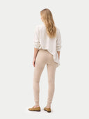 Over Bump Maternity Beige Cashmere Knit Pants worn by model back view on white backround