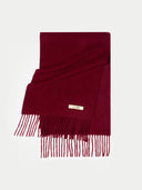 A deep burgundy wool scarf with fringe detailing and a small gold-tone metal brand tag reading 'GOBI', displayed on a clean white background. bordeaux