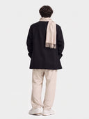 Model wearing the Natural Color Cashmere Woven Scarf in Beige, back view