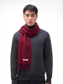 Model wearing the Cashmere Woven Scarf in Bordeaux around the neck, front view