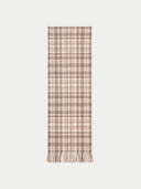 A long rectangular scarf with a beige and brown plaid pattern and fringed ends, shown flat against a light gray background.