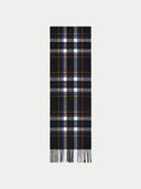 A long black plaid scarf with white, gray, and thin blue and orange stripes, finished with fringe at the bottom, shown on a light gray background.