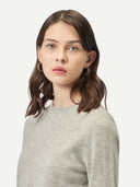 Women's Grey Cashmere Crew Neck Sweater worn by model, detail view on white background