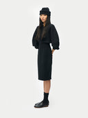 Women’s Black  Cashmere Sculptural Dressr worn by model, side view on white background