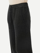 A pair of dark charcoal gray knit wide-leg pants with a drawstring waist, shown flat against a light gray background. #color_charcoal