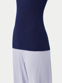 Woman wearing a navy sleeveless top and light gray wide-leg pants on a white background #color_dark-indigo

