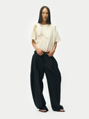 Barrel-Leg Cashmere Pants Black worn by model, detail view on white background