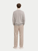 Man wearing a gray cashmere cardigan, beige turtleneck, and beige pants on a white background #color_steel-silver
