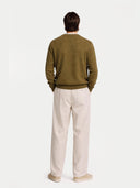 Man wearing a brown cashmere sweater on a white background. #color_muted-green