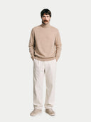 Men's Beige Turtleneck Cashmere Sweater worn by model, front view on white background