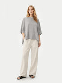 Women's Grey Knitted Poncho High Rise worn by model, front view, on white background
