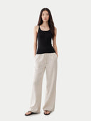 Woman wearing a black tank cashmere top against a white background #color_graphite-black