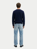 Men's Navy Cashmere Horse Intarsia Sweater worn by model, back view on white background