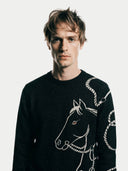 Men's  Black Cashmere Horse Jacquard Sweater worn by model, detail view on white background