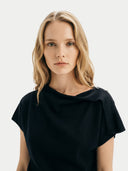 Women's Black Cashmere Asymmetrical Top worn by model, detail view on white background