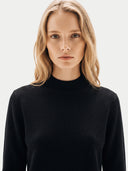The Cashmere Mock Neck Sweater in Black, shown worn.