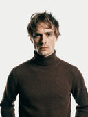 Men's Cocoa Turtleneck Cashmere Sweater worn by model, detail view on white background