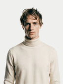 Men's Off-White Turtleneck Cashmere Sweater worn by model, detail view on white background