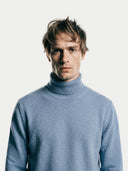 Men's Light Blue Turtleneck Cashmere Sweater worn by model, detail view on white background