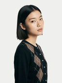 Women's Black Cashmere Argyle Cardigan worn by model, detail view on white background