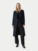 Woman wearing a long dark coat on a white background.