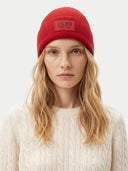 Model wearing warm red unisex cashmere beanie with turn-up cuff and GOBI lettering, front view