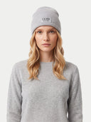 Model wearing light gray unisex cashmere beanie, front view with turn-up cuff and GOBI lettering